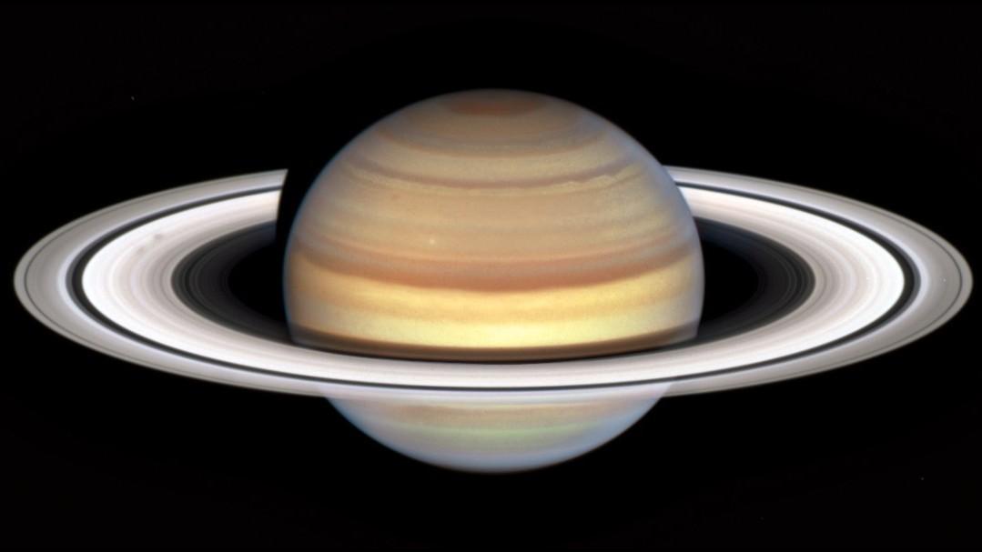 class="content__text"
 This new image of Saturn from the Hubble Space Telescope holds a subtle detail of great interest to ring-watchers: On the left, two dark smudges indicate the start of a new “spoke season.”

In the years surrounding Saturn’s equinox—which occurs every 16 Earth-years, with the next on May 6, 2025—mysterious, temporary spoke features have been spotted in the rings. They can appear light or dark against the rings, depending on the illumination and viewing angle. Closer to the equinox, their appearance is expected to become more frequent and distinct.

So far scientists have been unable to explain the spokes, which have a slightly different rotation rate than the rings themselves. In the next several years, Hubble’s Outer Planet Atmospheres Legacy (OPAL) program will be used to confirm or refute theories about the spokes, the most popular being that they result from interaction between the planet’s magnetic field and the solar wind, levitating ring particles to create the spoke features.

 #Hubble #Saturn #SaturnRings #SolarSystem #spokes

Credit: NASA, ESA, STScI, Hubble OPAL program; image processing: Alyssa Pagan (STScI).

ALT TEXT: Planet Saturn with bright white rings and multi-colored main sphere. Spoke features on the left side of the rings appear like faint gray smudges against the rings’ bright backdrop, about midway from the planet to the rings' outer edge. Above the rings plane, the planet's bands are shades of red and orange, with brighter yellow nearer the equator. 
 